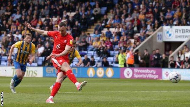 Will Keane scores from the penalty spot for Wigan Athletic