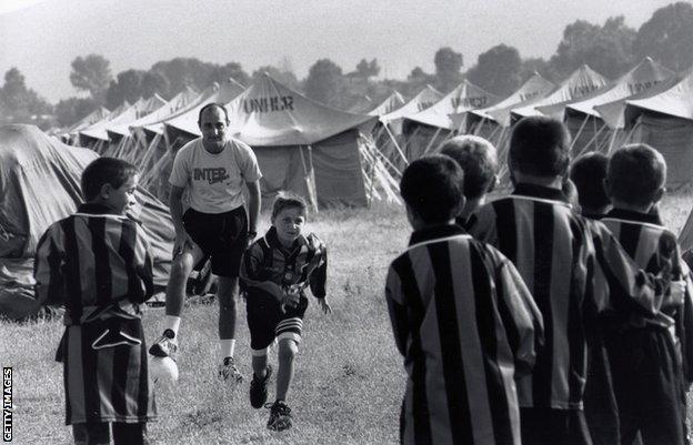 Kosovan boys play football at an Intercampus training session in a refugees Camp in Albania during the Kosovo war