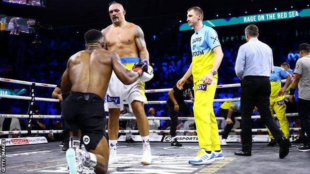 Oleksandr Usyk helped Anthony Joshua to his feet