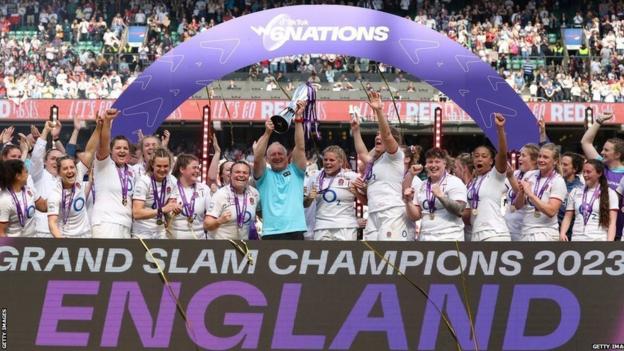 England's women's rugby team celebrate with the trophy after winning the 2023 Six Nations
