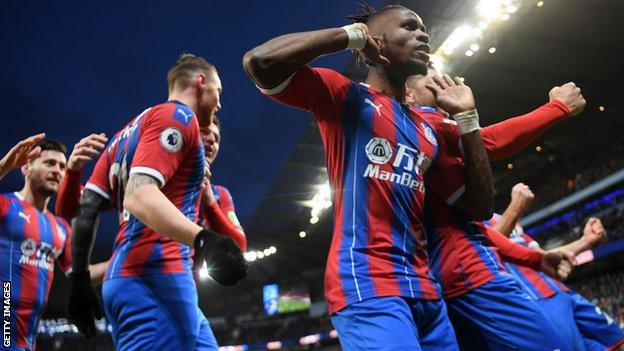 Wilfried Zaha celebrates after Fernandinho's late own goal for Manchester City