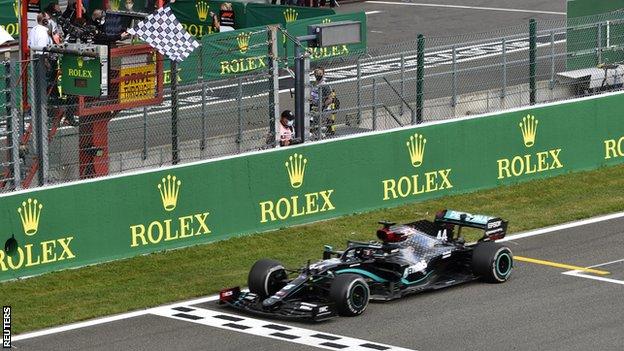 Lewis Hamilton takes the chequered flag at Spa