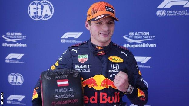Max Verstappen holds up his pole position tyre award