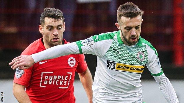 Larne's Mark Randall in action with Conor McMenamin of Cliftonville