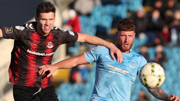 Crusaders' Adam Lecky and Ballymena's Kym Nelson