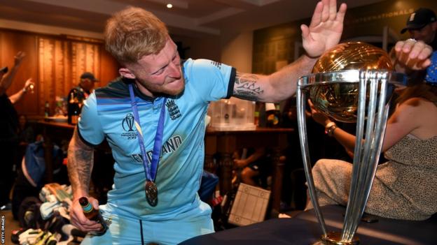 Ben Stokes taps the World Cup trophy