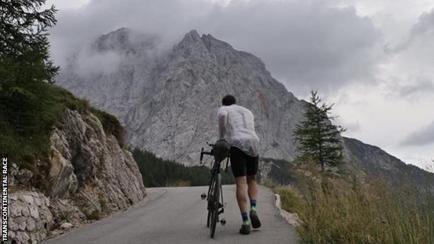 A competitor walks their bike up an extremely steep climb at the Transcontinental race of 2018