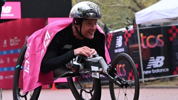 Marcel Hug celebrates winning the men's wheelchair race