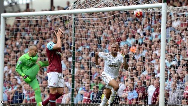 Andre Ayew celebrates as Darren Randolph and Aaron Cresswell show their dejection