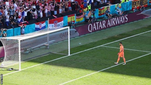 Unai Simon walks back towards his net after the own goal