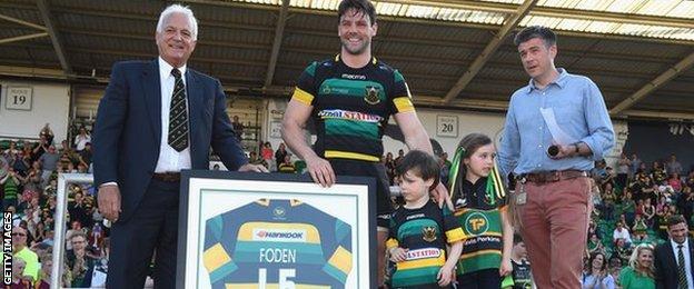 Ben Foden of Northampton Saints is presented with a club shirt after playing his last match for Northampton Saints