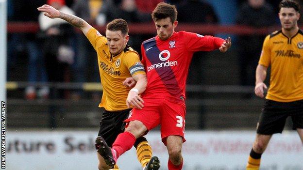 Mark Byrne of Newport battles away with York's Kenny McEvoy