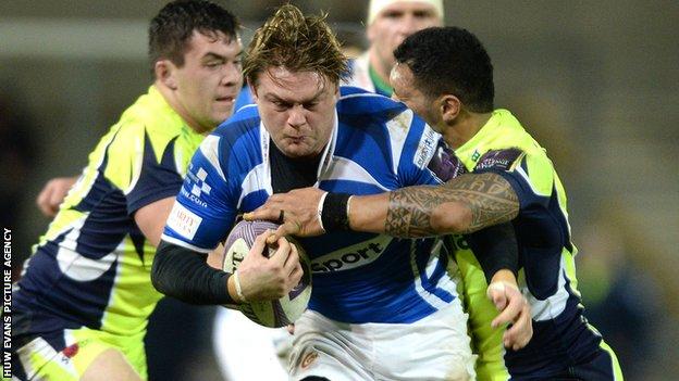 Dragons forward Lewis Evans is tackled by Sale's Johnny Leota