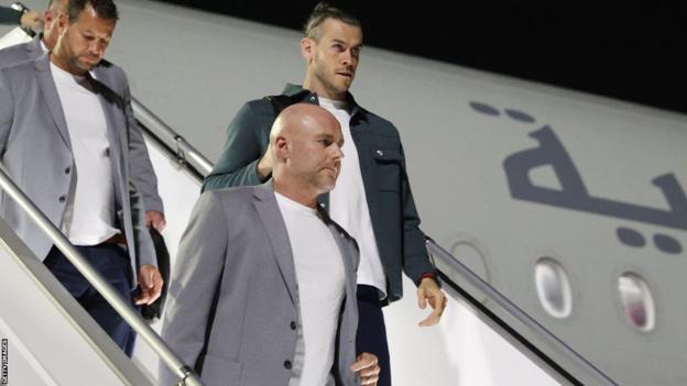 Manager Robert Page (front centre) and Gareth Bale (back right) arrive in Qatar