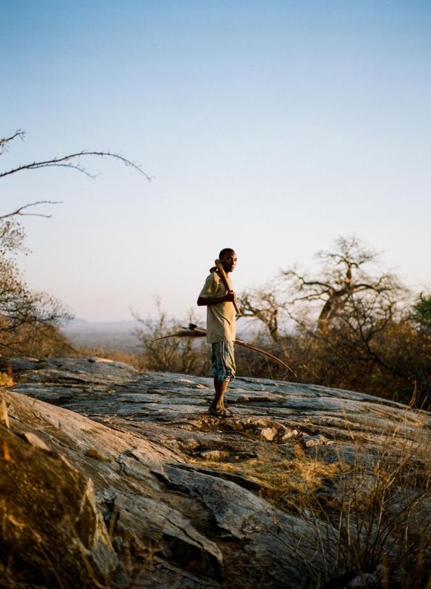 A Hadza man poses with his hunting equipment