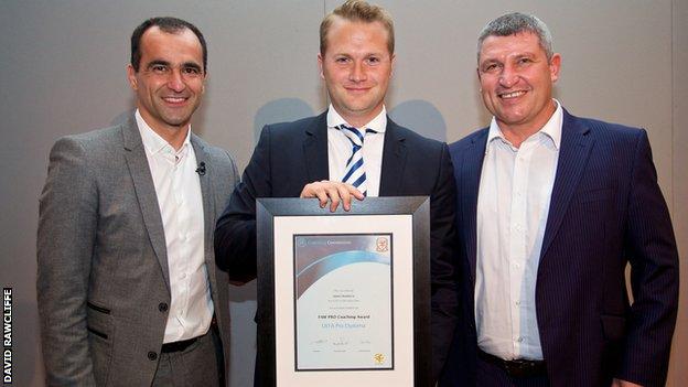 Former Swansea City manager Roberto Martinez (left) and Wales assistant Osian Roberts (right) present James Rowberry (centre) with his pro-licence certificate in 2014