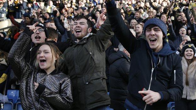 Oxford fans celebrate beating Swansea City in the FA Cup