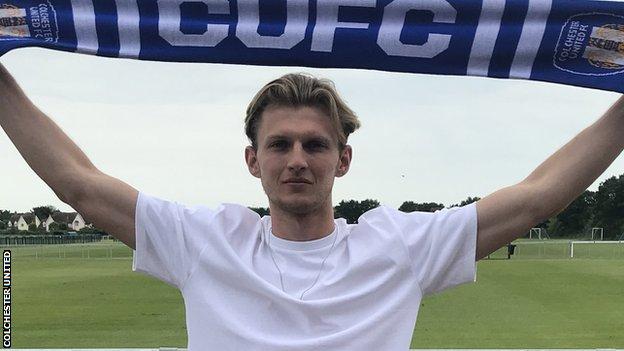 Danny Collinge poses with a Colchester scarf