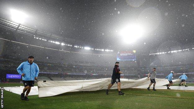 Ground unit   pulling covers implicit    a bedewed  outfield astatine  the MCG