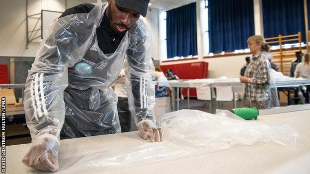 Blair Turgott helps prepare PPE for a local hospital