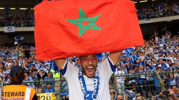 Gent's Tarik Tissoudali celebrates with a Moroccan flag