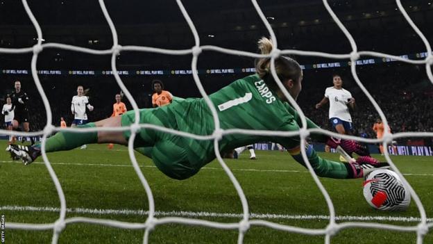 England's Mary Earps lets a shot from the Netherlands' Lineth Beerensteyn through her hands