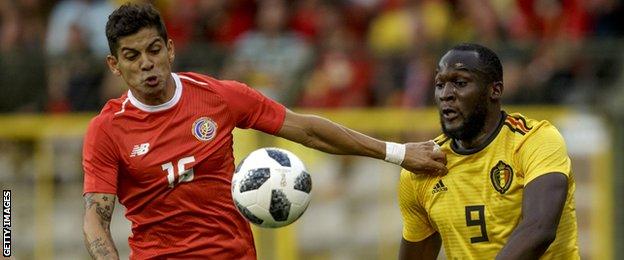 Costa Rica's Cristian Gamboa challenges Belgium's Romelu Lukaku