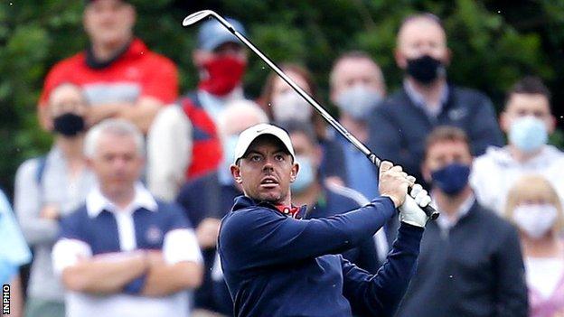 Rory McIlroy watches his approach shot to the 10th hole on Friday