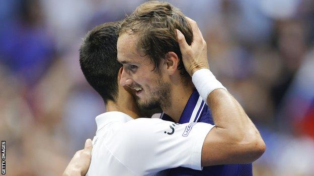 Daniil Medvedev hugs Novak Djokovic