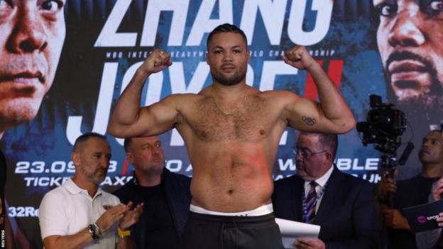 Joe Joyce poses for the cameras after weighing in