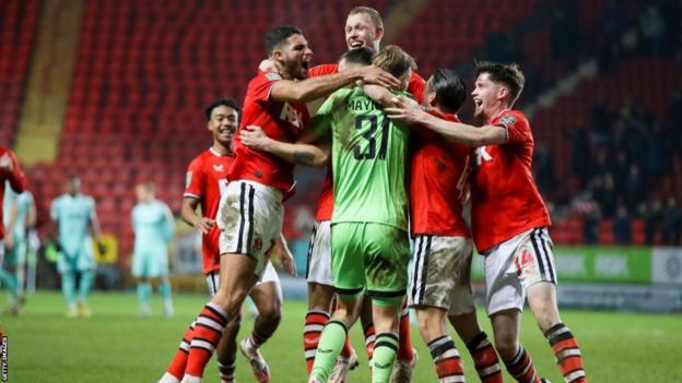 Charlton players celebrate beating Brighton