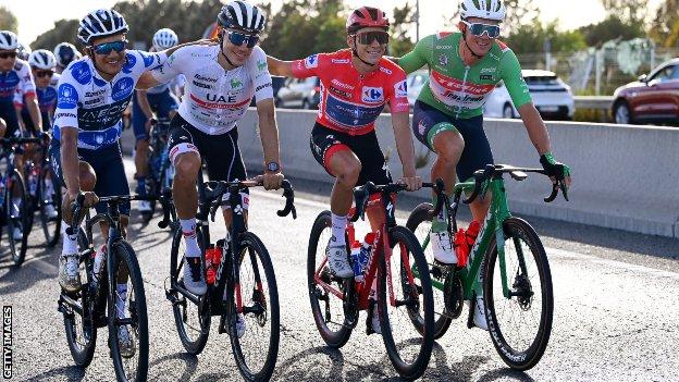 From left, Richard Carapaz in polka dot mountain jersey, Juan Ayuso Pesquera in white jersey as best young rider, overall winner Remco Evenepoel and green jersey winner Mads Pedersen