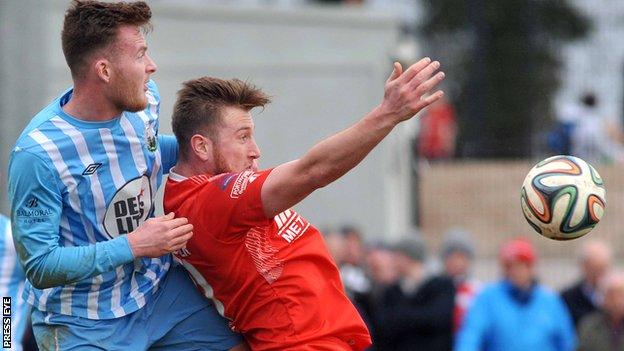Warrenpoint's Dermot McVeigh challenges Portadown striker Mark McAllister
