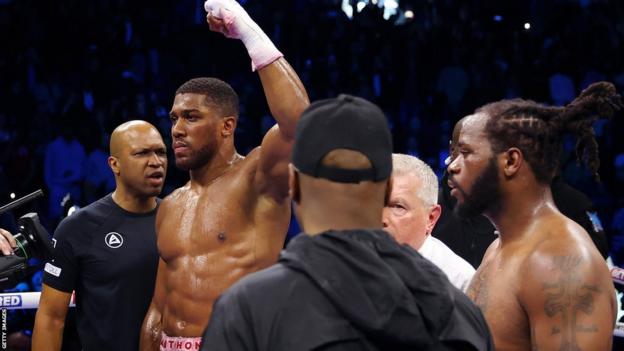 Anthony Joshua celebrates victory