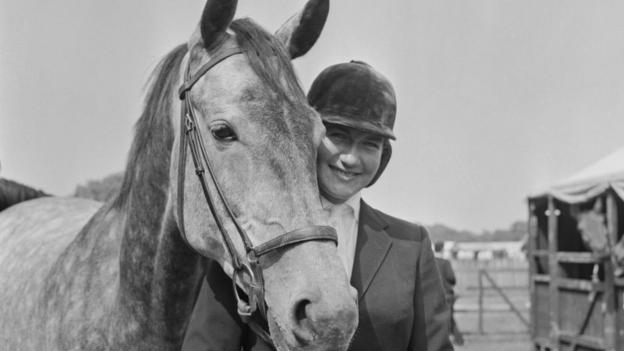 Anneli Drummond-Hay poses with her horse in 1965