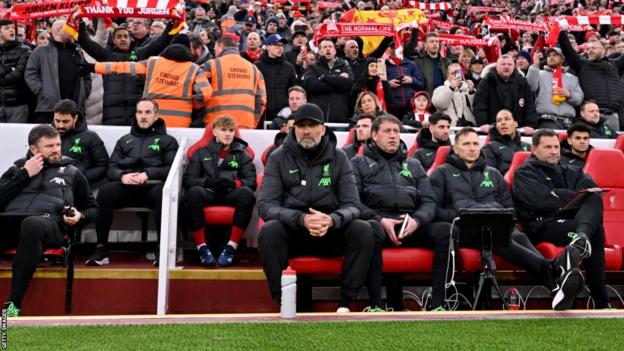 Jurgen Klopp takes his seat in the dugout prior to Liverpool's FA Cup victory over Norwich