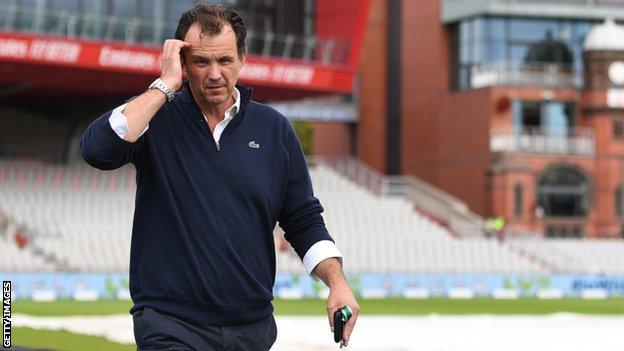 England and Wales Cricket Board chief executive Tom Harrison walks around the outfield at Old Trafford
