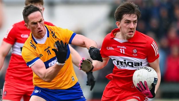 Clare's Eoin Cleary attempts to halt Derry's Paul Cassidy
