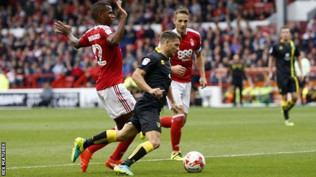 Wes Hoolahan of Norwich is fouled by Nottingham Forest's Nicolao Dumitru and wins a penalty