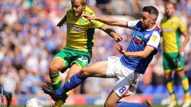 Norwich's Teemu Pukki and Ipswich's Cole Skuse battle for the ball