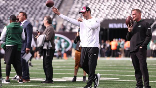 Aaron Rodgers throwing a football