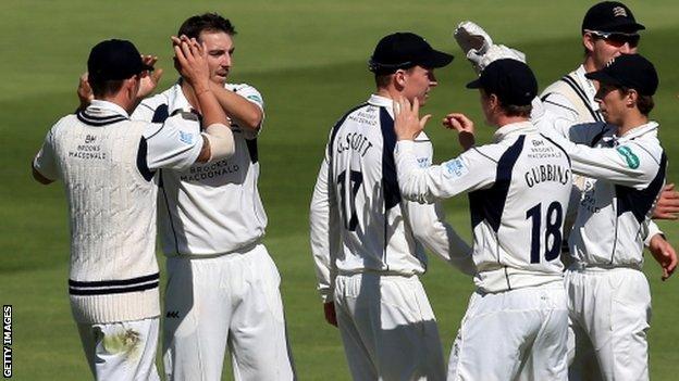 Middlesex players celebrate the wicket of Jonathan Trott, who went cheaply in the morning session