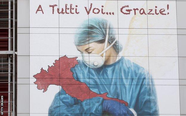 A mural dedicated to Italian medical workers depicts a nurse cradling Italy and reads: 'To All Of You... Thank You!', on a wall of Papa Giovanni XXIII Hospital on March 25, 2020 in Bergamo