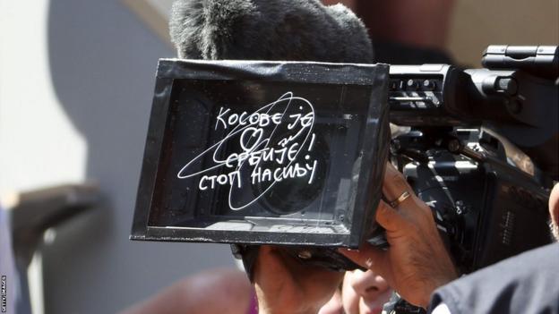 The camera lens with Novak Djokovic's message written on it