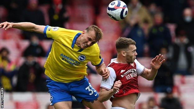 Brighton's Dan Burn and Arsenal's Calum Chambers attempt to head the ball