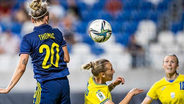 Striker Martha Thomas heads in Scotland's fourth goal against Ukraine