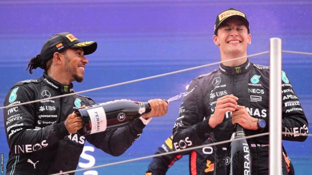 Lewis Hamilton sprays George Russell with champagne