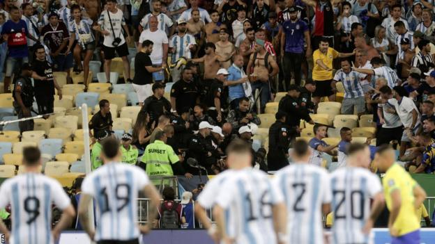Argentina players looking on as trouble breaks out in the stands