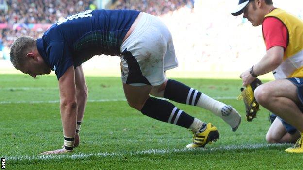 Finn Russell of Scotland sustains an injury
