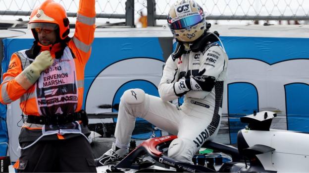 Daniel Ricciardo sits on his Alha Tauri after a crash